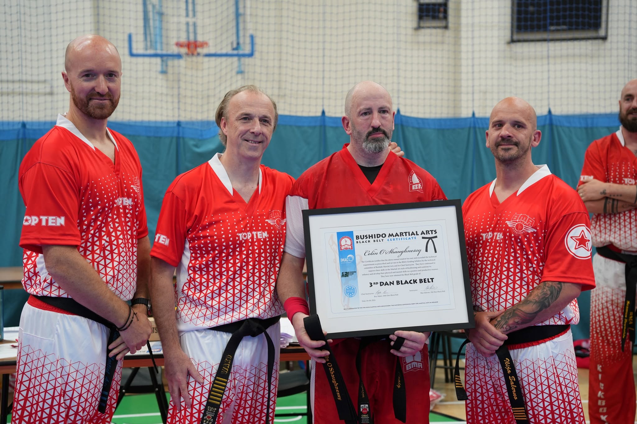 Bushido coaches presenting a certificate to a student